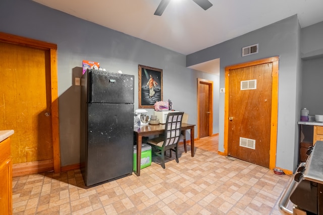 kitchen with ceiling fan and black refrigerator