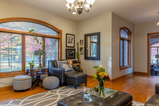 living area with a chandelier and hardwood / wood-style floors