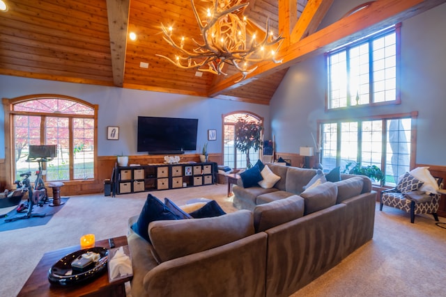 living room with beam ceiling, carpet floors, an inviting chandelier, and wooden ceiling