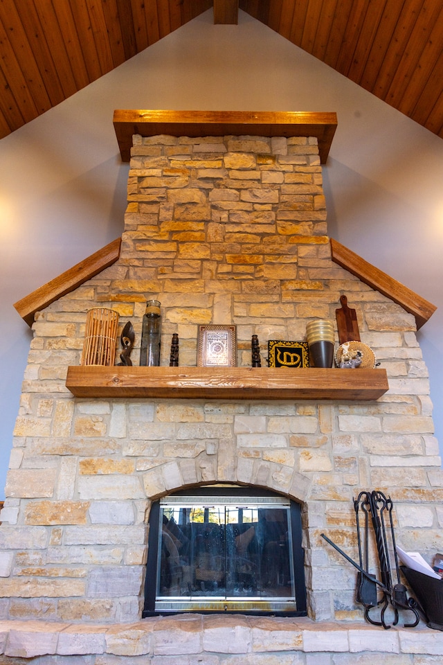 room details featuring a stone fireplace and wooden ceiling