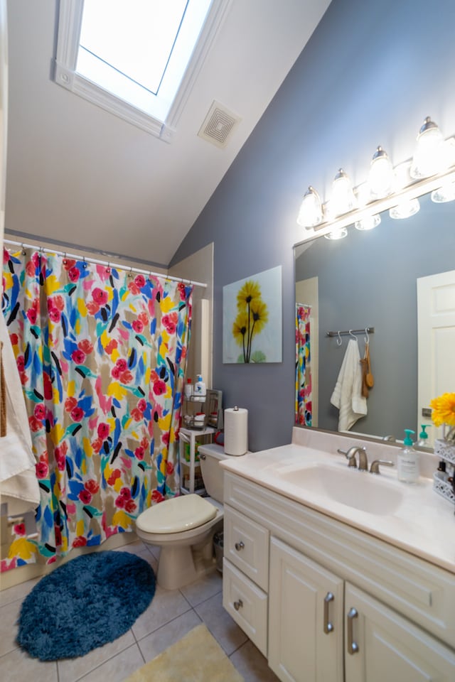 bathroom featuring toilet, walk in shower, vanity, lofted ceiling with skylight, and tile patterned flooring