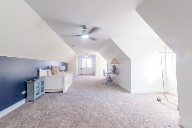 bedroom featuring light colored carpet, vaulted ceiling, and ceiling fan