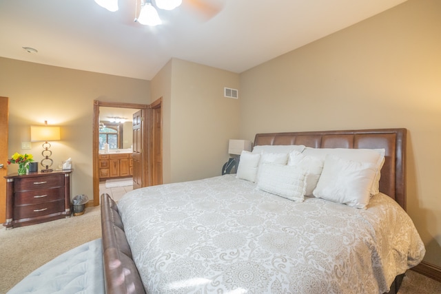 carpeted bedroom featuring ensuite bathroom and ceiling fan