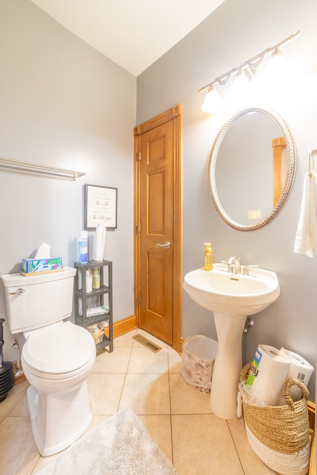 bathroom with toilet and tile patterned flooring