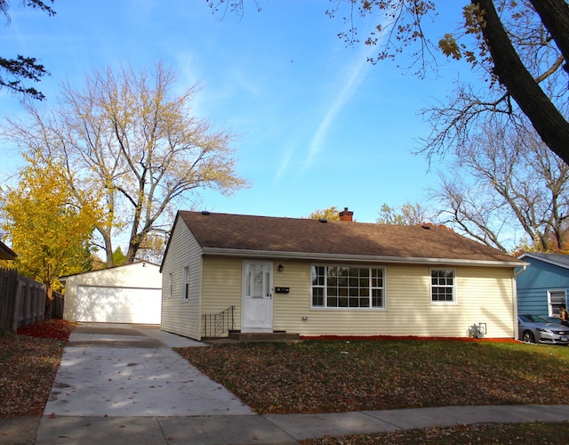 view of front facade featuring an outdoor structure and a garage