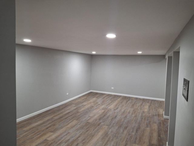 finished basement with recessed lighting, wood finished floors, and baseboards