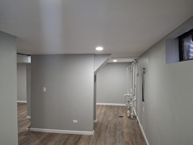 finished basement featuring recessed lighting, baseboards, and wood finished floors