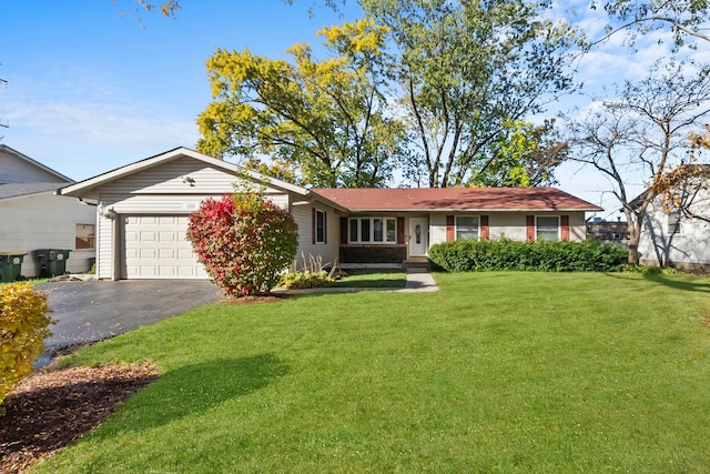 single story home with a front yard and a garage