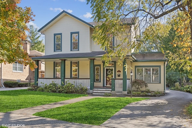 view of front facade with a front yard and a porch