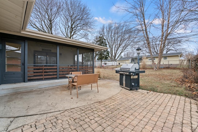 view of patio with a sunroom and area for grilling