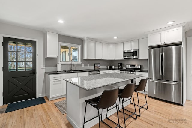 kitchen with sink, white cabinetry, and stainless steel appliances