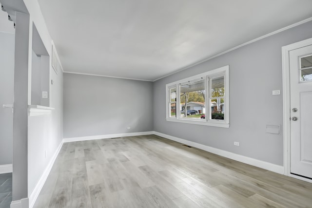 interior space featuring ornamental molding and light wood-type flooring