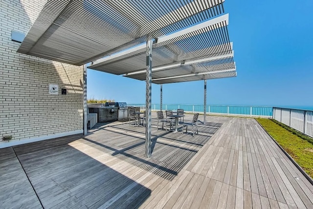 deck featuring an outdoor kitchen and a water view