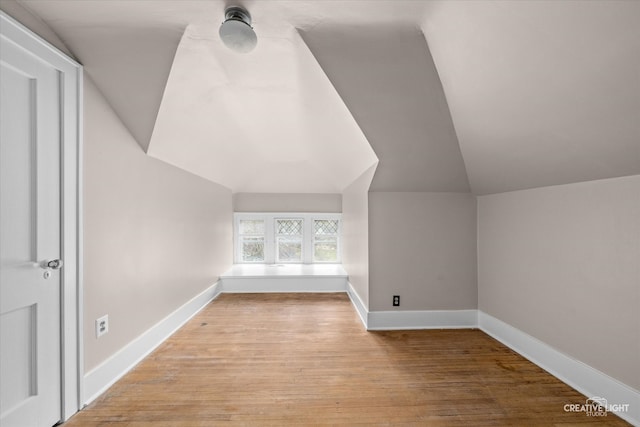 bonus room featuring hardwood / wood-style flooring and vaulted ceiling