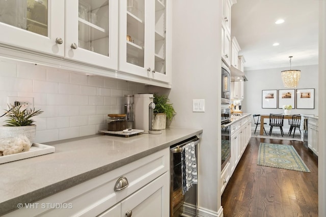 bar with wine cooler, white cabinetry, decorative light fixtures, and tasteful backsplash