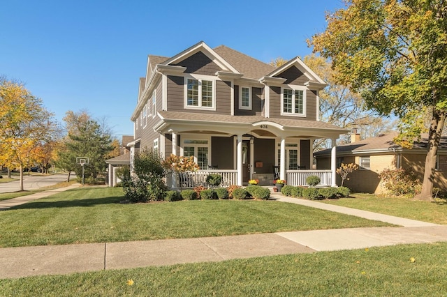 craftsman-style house with a front yard and covered porch