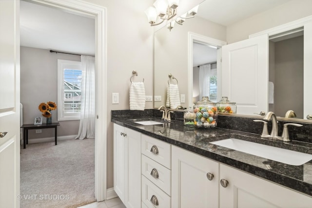 bathroom featuring an inviting chandelier and vanity