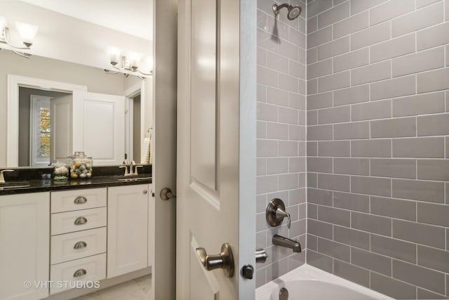 bathroom featuring vanity and tiled shower / bath combo