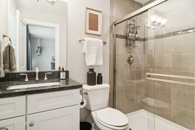 bathroom featuring walk in shower, vanity, and toilet