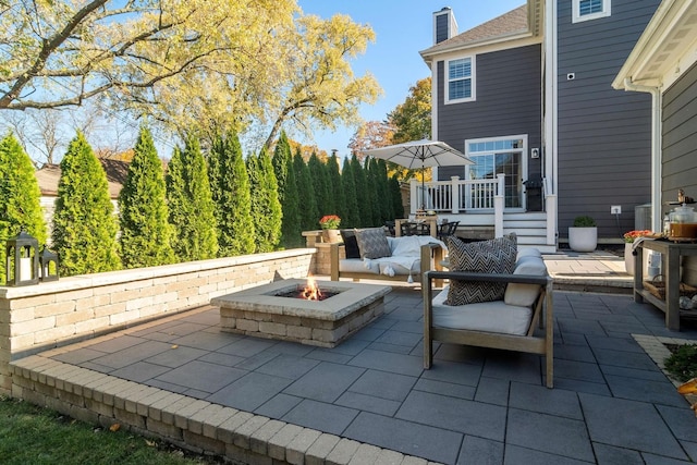 view of patio / terrace featuring an outdoor living space with a fire pit