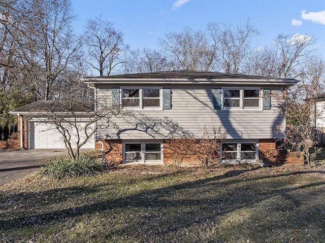 view of front of house featuring a garage and a front lawn