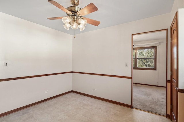 unfurnished room with ceiling fan and light carpet