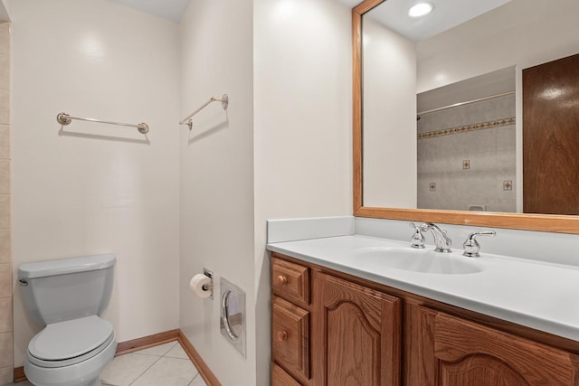 bathroom featuring tile patterned flooring, vanity, and toilet