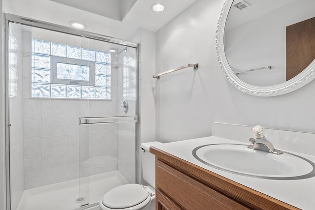 bathroom with vanity, toilet, and walk in shower