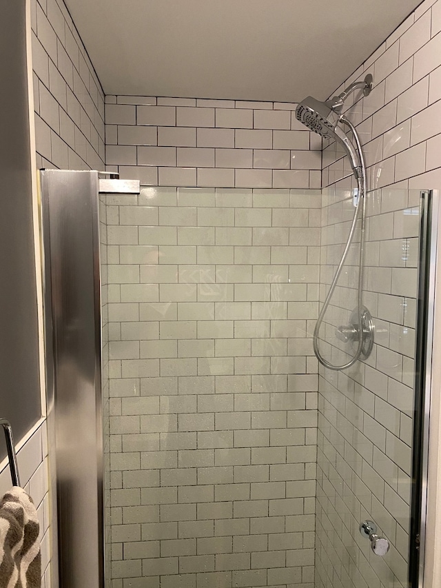 bathroom with tiled shower