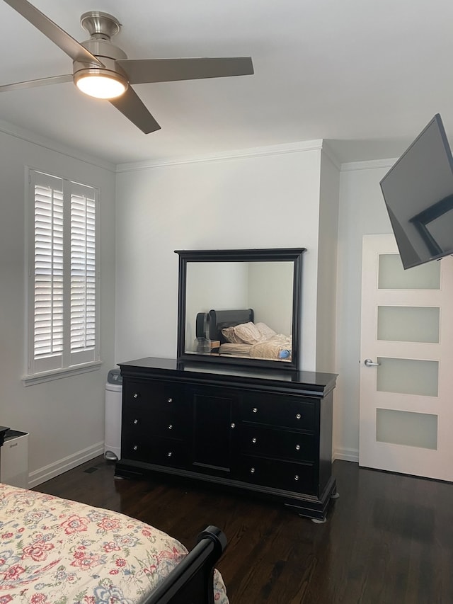 bedroom featuring ceiling fan, crown molding, and dark hardwood / wood-style flooring