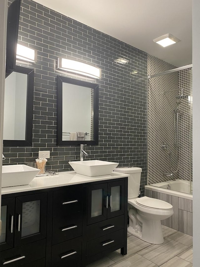1334 S Wabash Ave Unit B, Chicago, IL 60605 - full bathroom with tile walls, tiled shower / bath, double vanity, toilet, and backsplash
