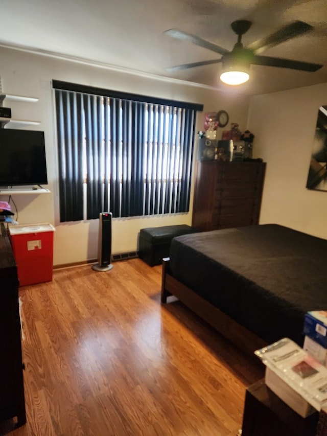 bedroom featuring hardwood / wood-style floors and ceiling fan