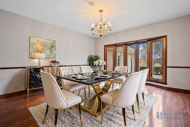 dining area featuring wood-type flooring and a notable chandelier