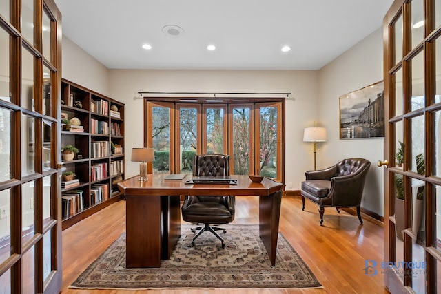 home office featuring french doors and light hardwood / wood-style flooring