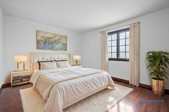 bedroom with dark hardwood / wood-style flooring