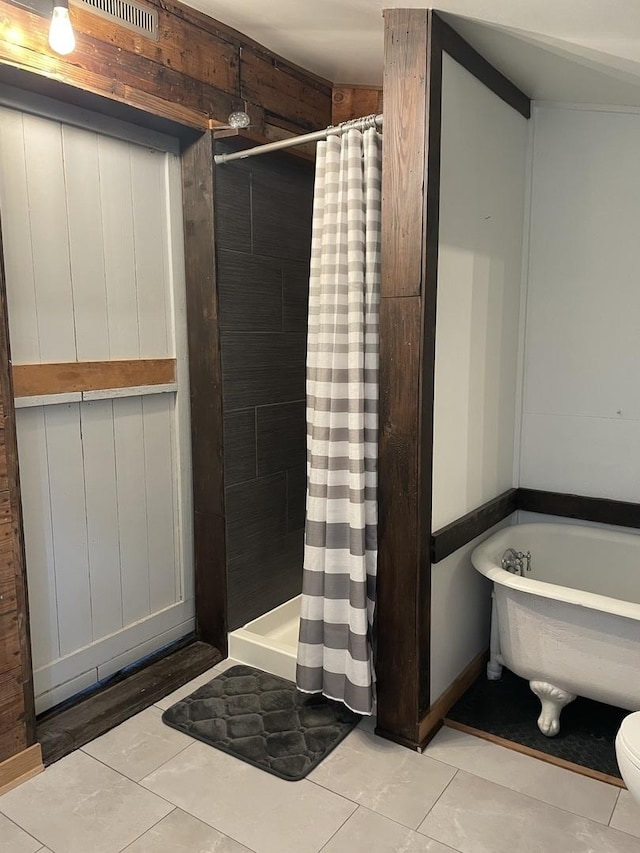 bathroom featuring tile patterned floors, separate shower and tub, and toilet