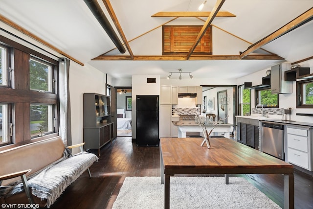 interior space with backsplash, black refrigerator, stainless steel dishwasher, and plenty of natural light