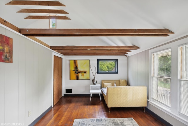 living area with dark hardwood / wood-style floors, beam ceiling, and wooden walls