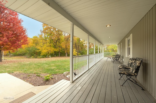 wooden deck featuring a yard and covered porch