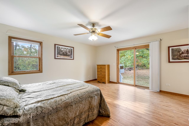 bedroom with access to outside, multiple windows, light hardwood / wood-style floors, and ceiling fan