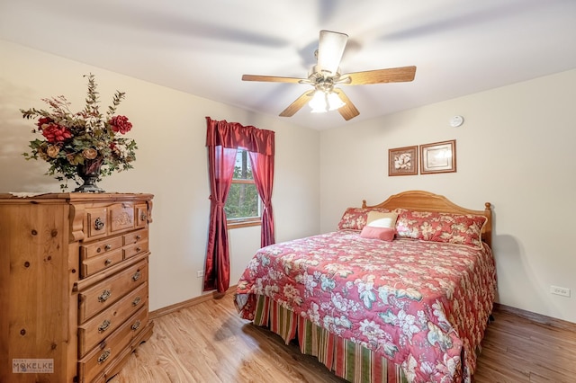 bedroom with light hardwood / wood-style floors and ceiling fan