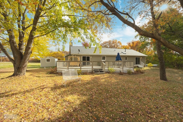 back of property with a storage shed and a deck