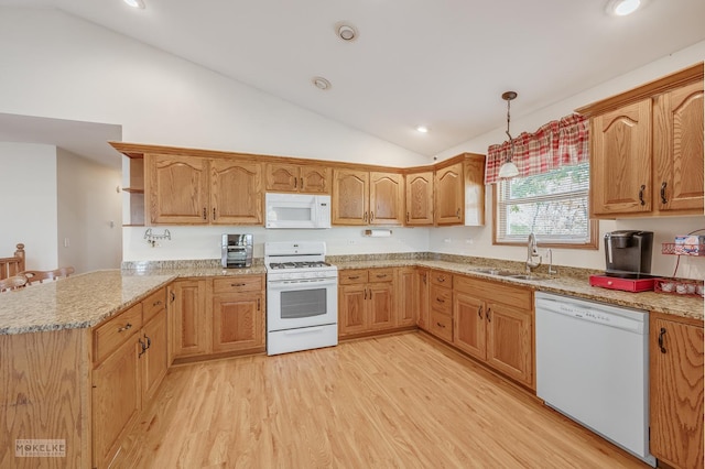 kitchen featuring pendant lighting, white appliances, sink, light hardwood / wood-style floors, and kitchen peninsula