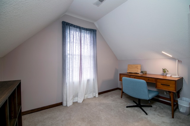 home office featuring light colored carpet, a textured ceiling, and lofted ceiling