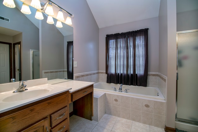 bathroom featuring tile patterned flooring, vanity, plus walk in shower, and vaulted ceiling