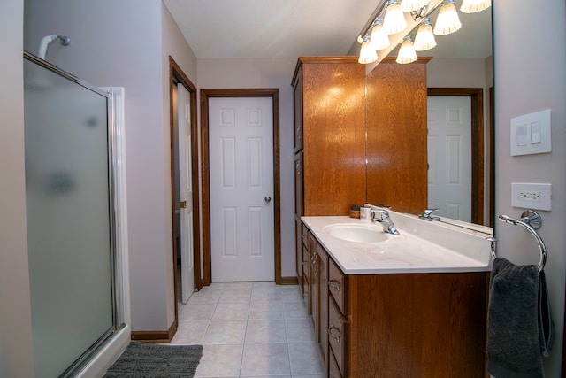 bathroom with walk in shower, vanity, and tile patterned floors