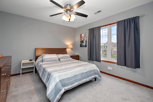 bedroom with ceiling fan, multiple windows, and carpet flooring