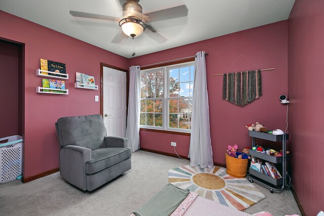 living area with light colored carpet and ceiling fan