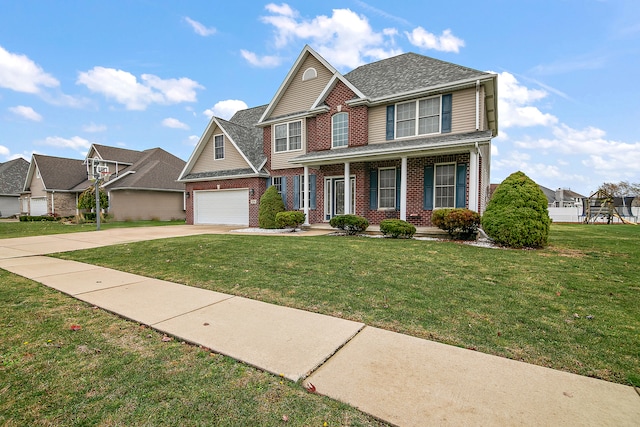 view of front of property with a garage, a front yard, and covered porch