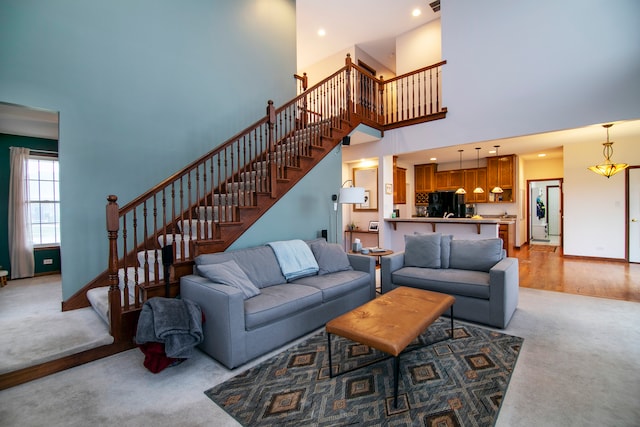 living room featuring a high ceiling and light hardwood / wood-style floors